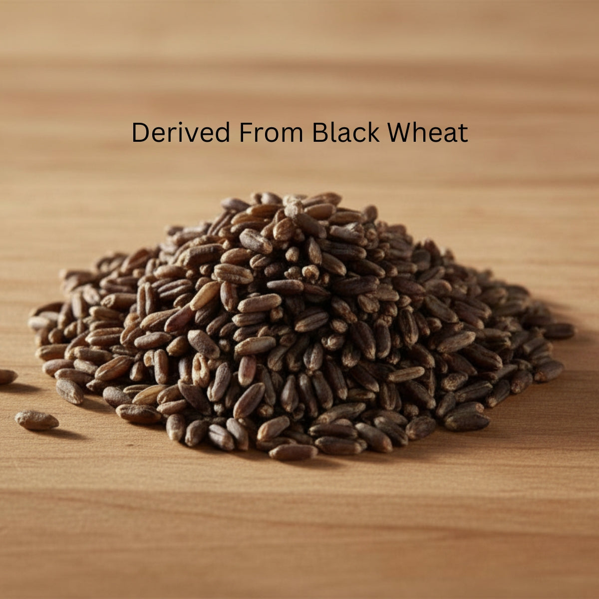 Pile of black wheat seeds on a wooden surface with text 'Derived From Black Wheat'.